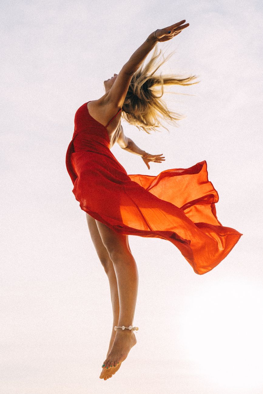jumping woman in red dress